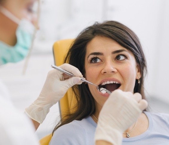 Woman receiving cracked tooth treatment from dentist