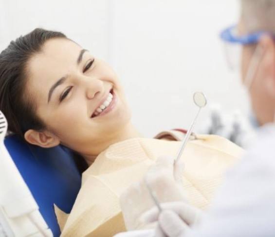 Young woman smiling right before getting a root canal